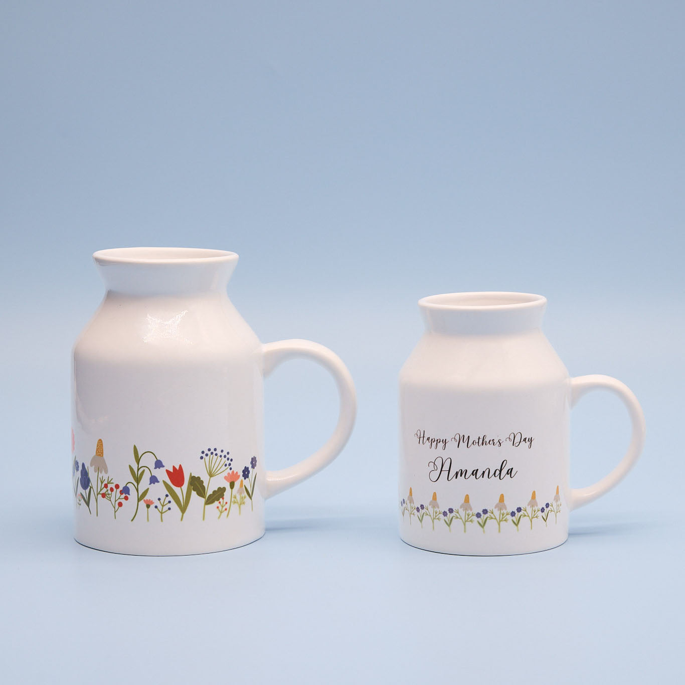 Two ceramic sublimation milk jugs with floral designs on a light blue background